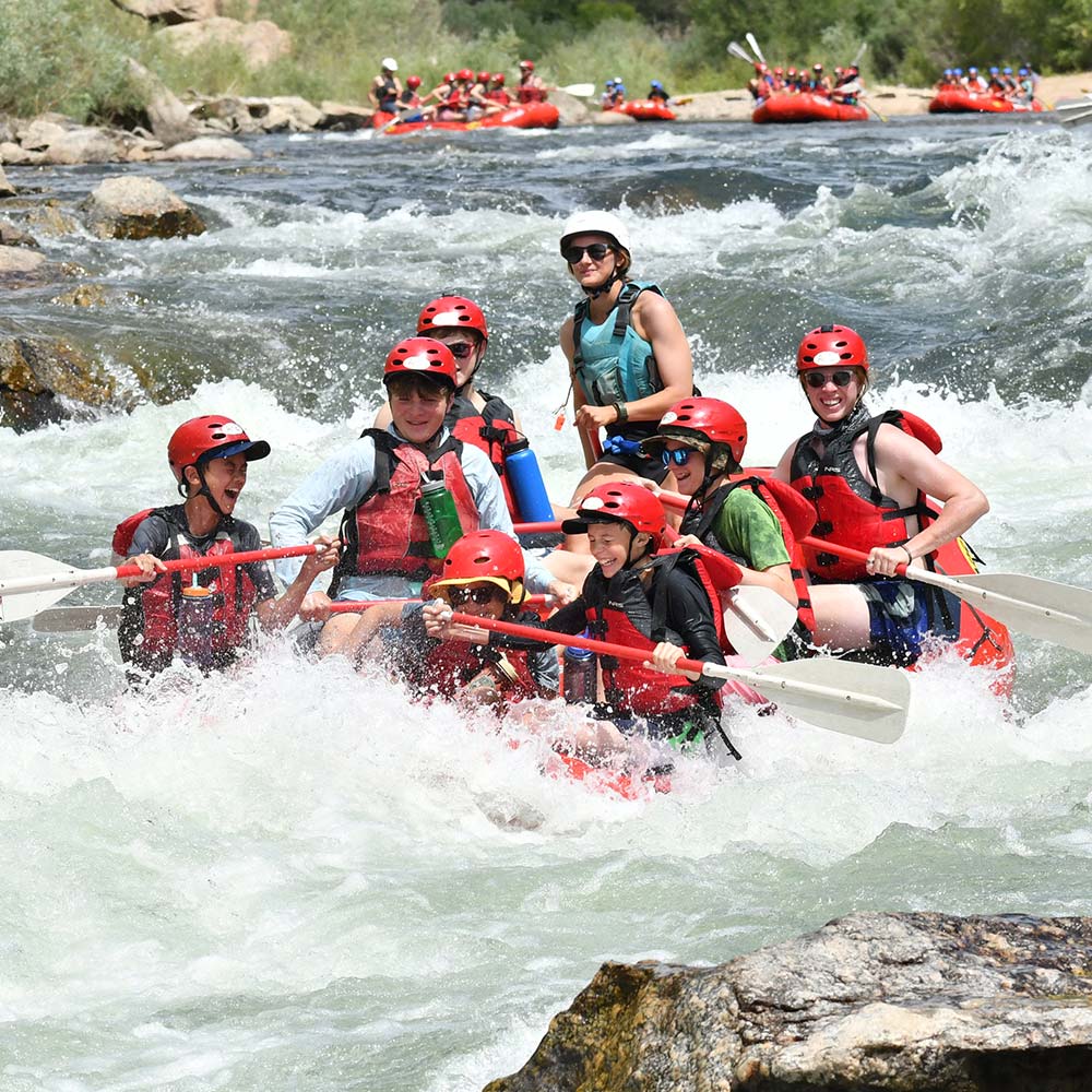 Campers go through the rapids on a whitewater rafting trip