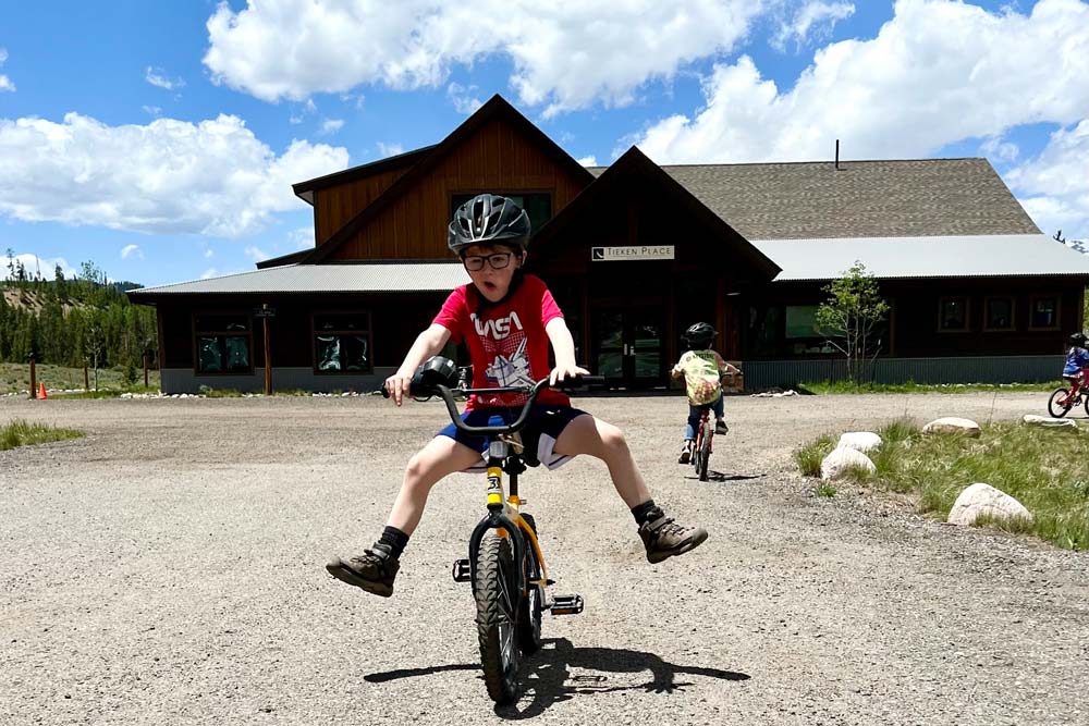 Day camper learning to ride a bike