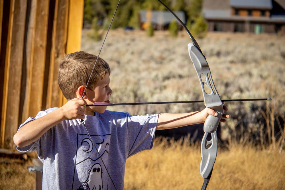 Practicing archery during Harvest Camp in the fall colors