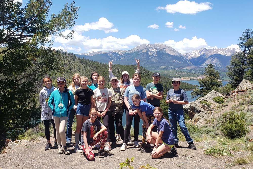 Group of Pathfinders on a hike in front of Lake Dillon.