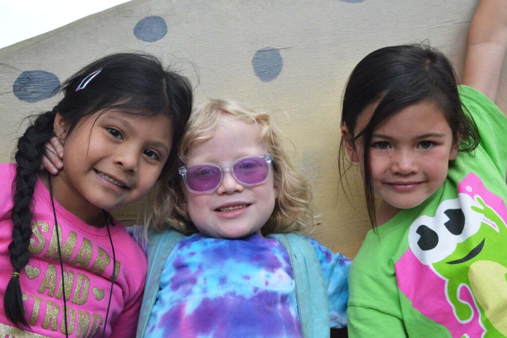 A group of Day Campers pose in front of the Fish Hatchery