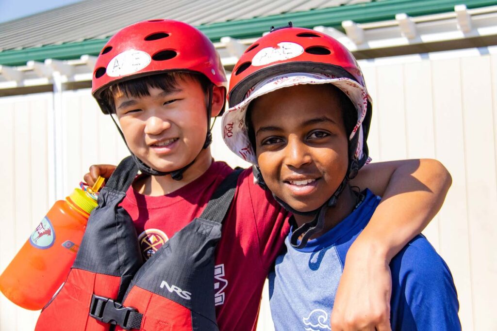 Two Discovery Campers are ready to go rafting with their PFDs and helmets!