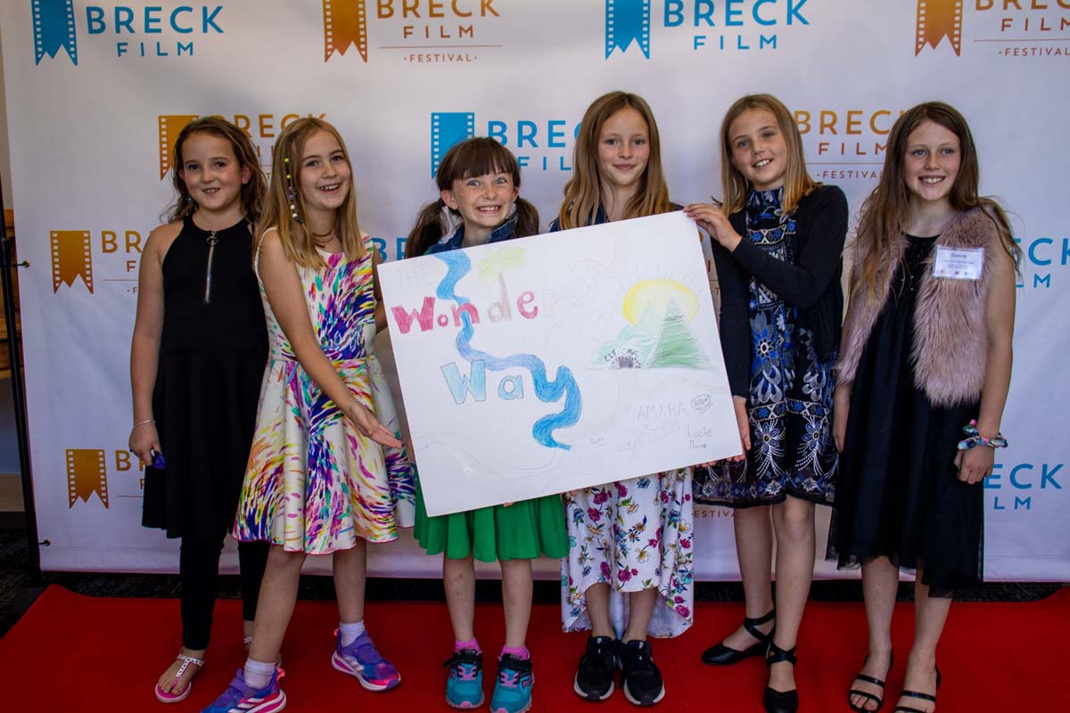 A group of our Girls in STEM Film Fest students walk down the red carpet at the Breck Film Fest