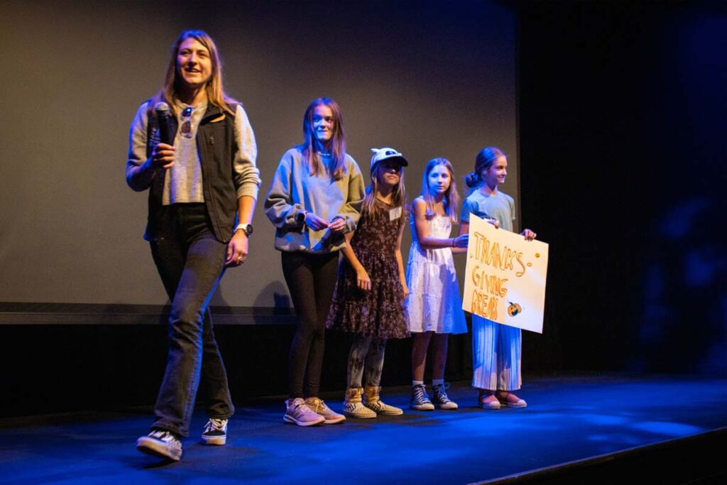 Girls in STEM Film Fest students present their film on stage at the Breck Film Fest