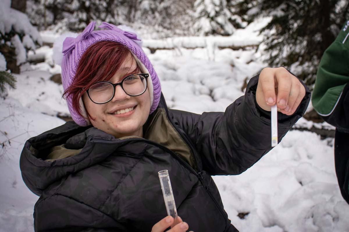 An H2O Outdoors student performing a water chemical test