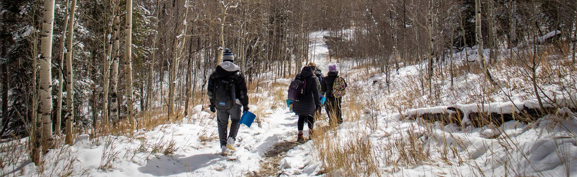 H2O Outdoors students hiking to a river in the mountains.