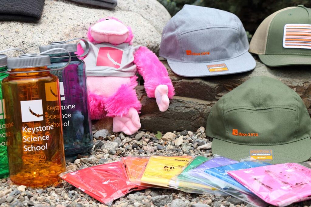 A spread of our School Store items for sale - hats, bottles and the HPG plushie