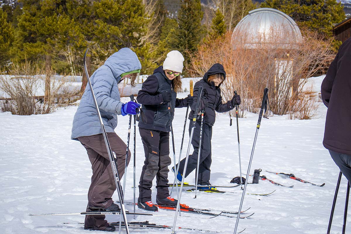 Outdoor Education students practicing putting on cross country skiis.