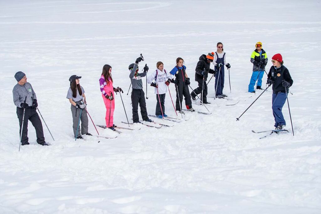A field trip group learning to cross country ski in our campus field.