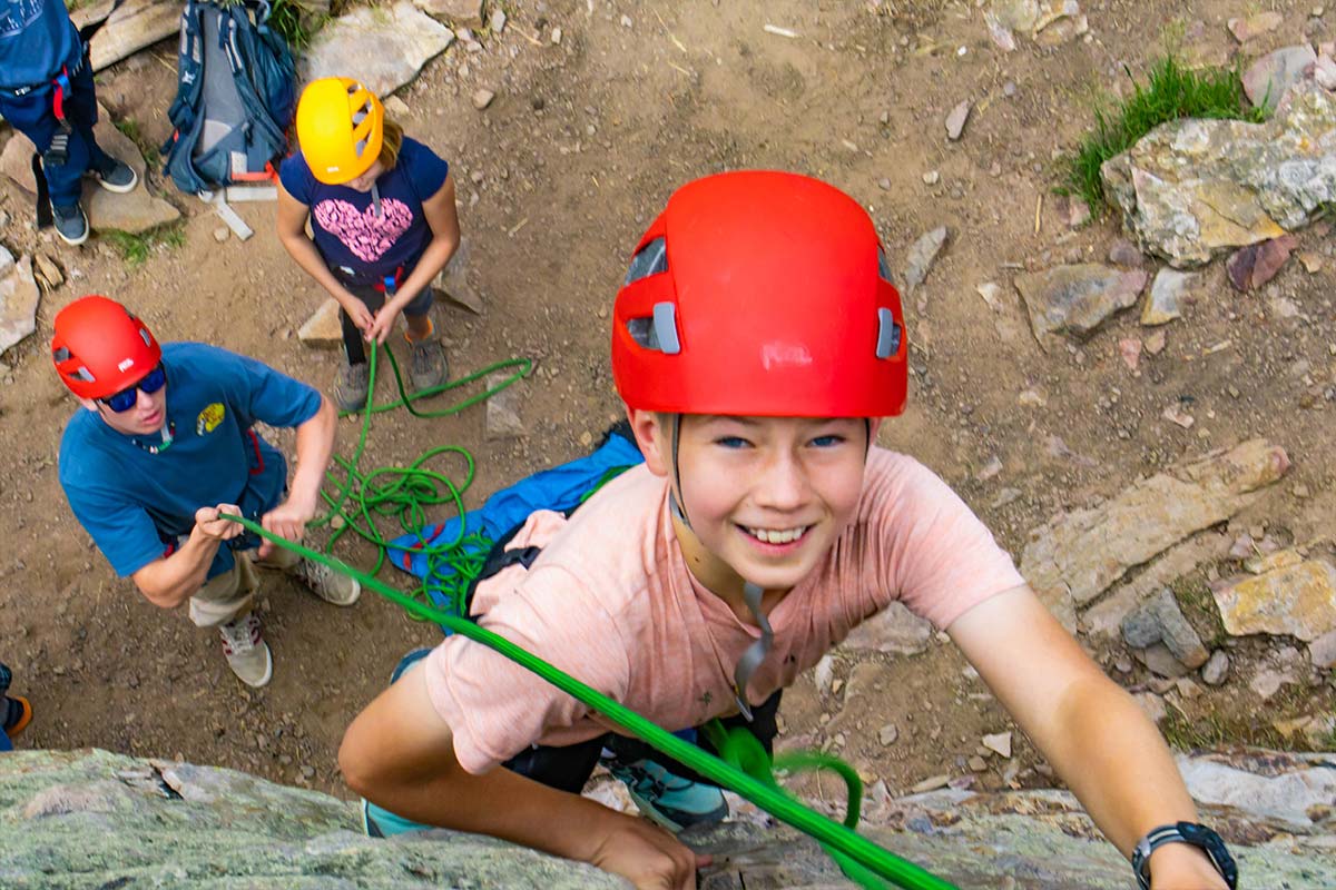 A girl looks up during an adventure rock climbing day at KSS summer camp.