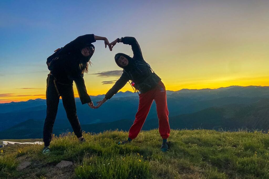 Two CAPs form a heart on top of a mountain at sunrise