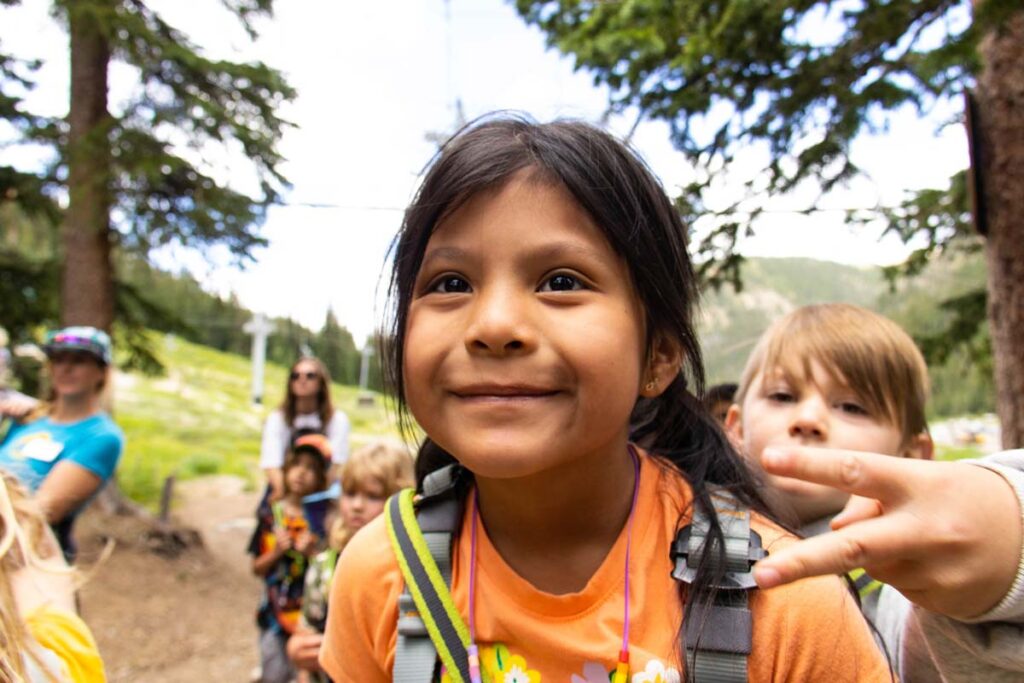 Camper smiling during the ropes course adventure day