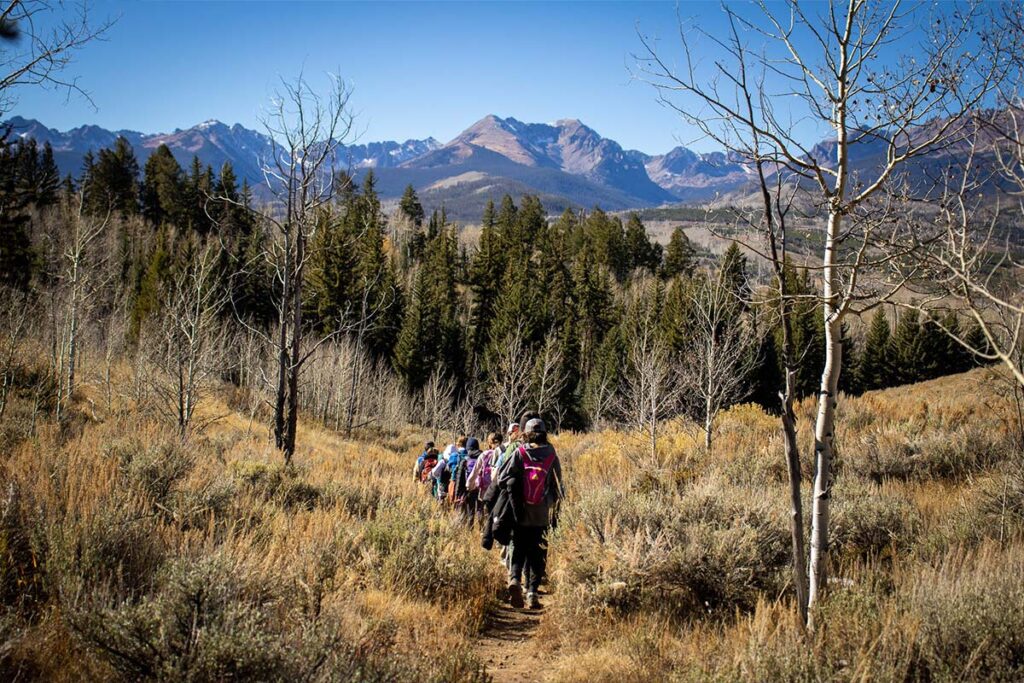 Harvest Camp group hiking through the mountains