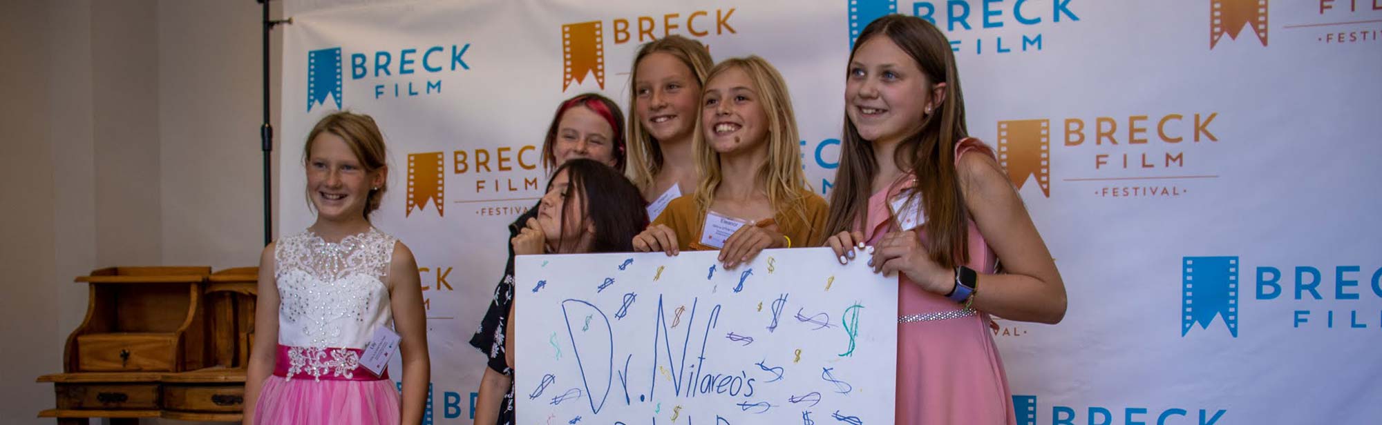 A group of Girls in STEM students walk the red carpet to show their short film