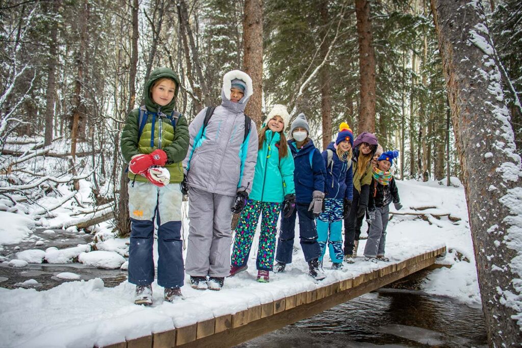 The Girls in STEM Water in the West poses for a photo on a bridge crossing