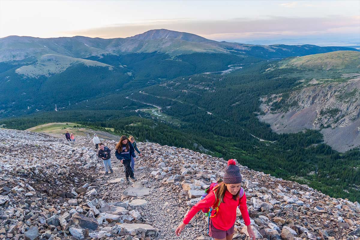 Discovery campers hike up the mountain at sunrise