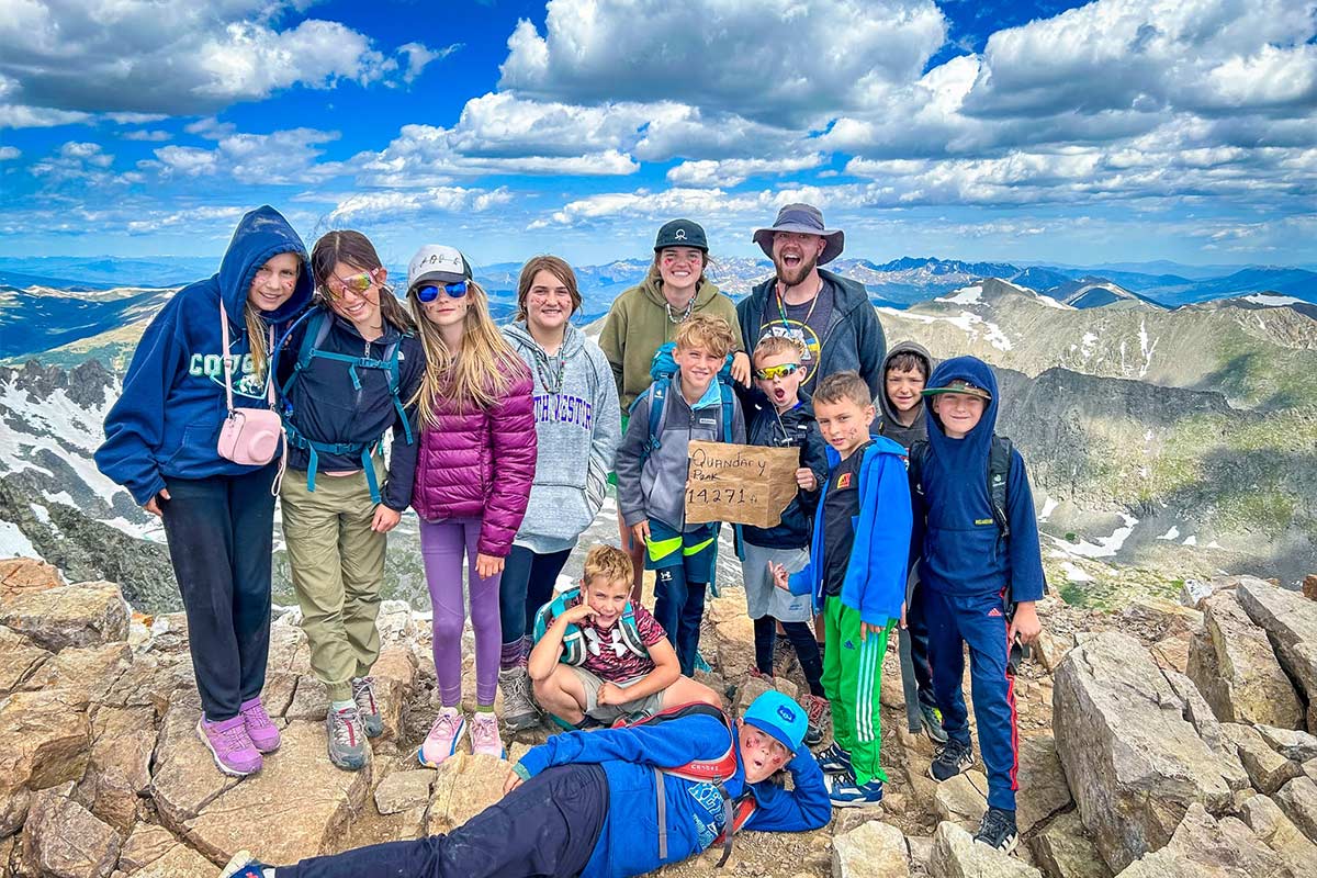 A Discovery Camp group at the summit of Quandary Peak in summer 2023