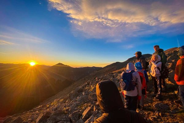 Discovery campers looking at the mountain sunrise during a challenge hike