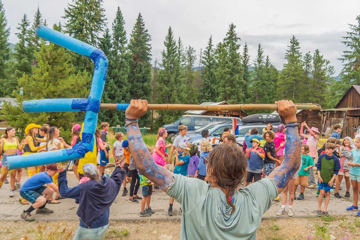 A counselor holds the Blue Mermaids trident during CLAW