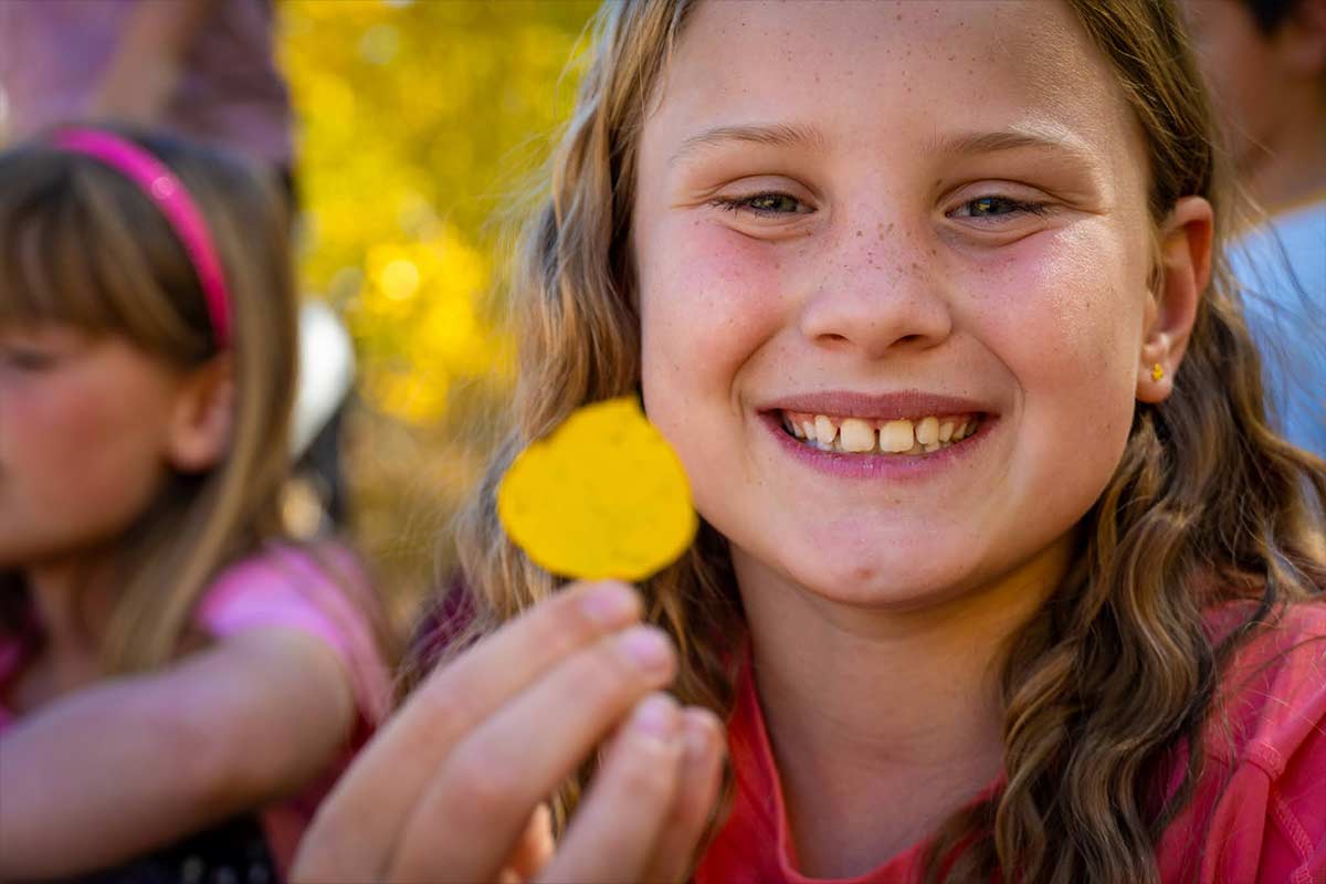 An outdoor education student examines the yellow autumn colors in Summit County. 